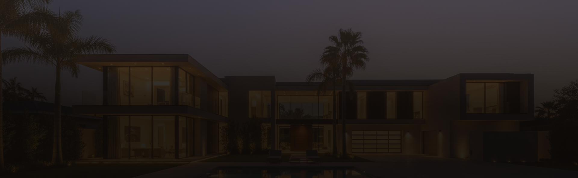 Luxury villa with pool and palm trees at dusk